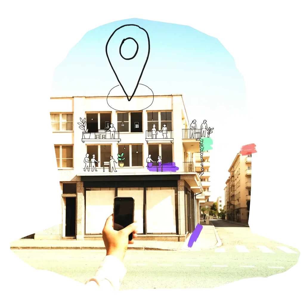 A phone held up to photograph an empty shopfront, with a map pin drawn above it
