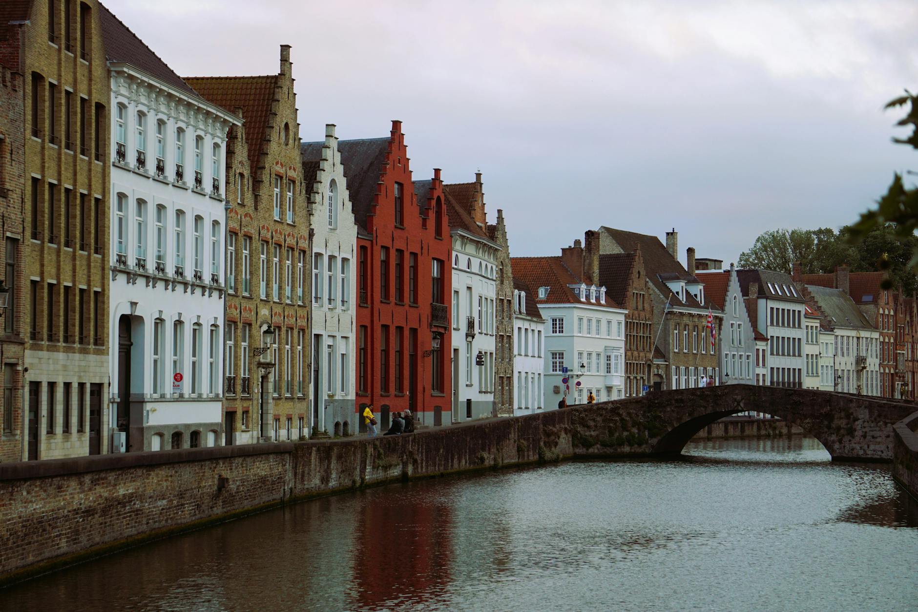 Picturesque view of historic canal houses and bridge in Brussels. Ideal for architecture and travel visuals.