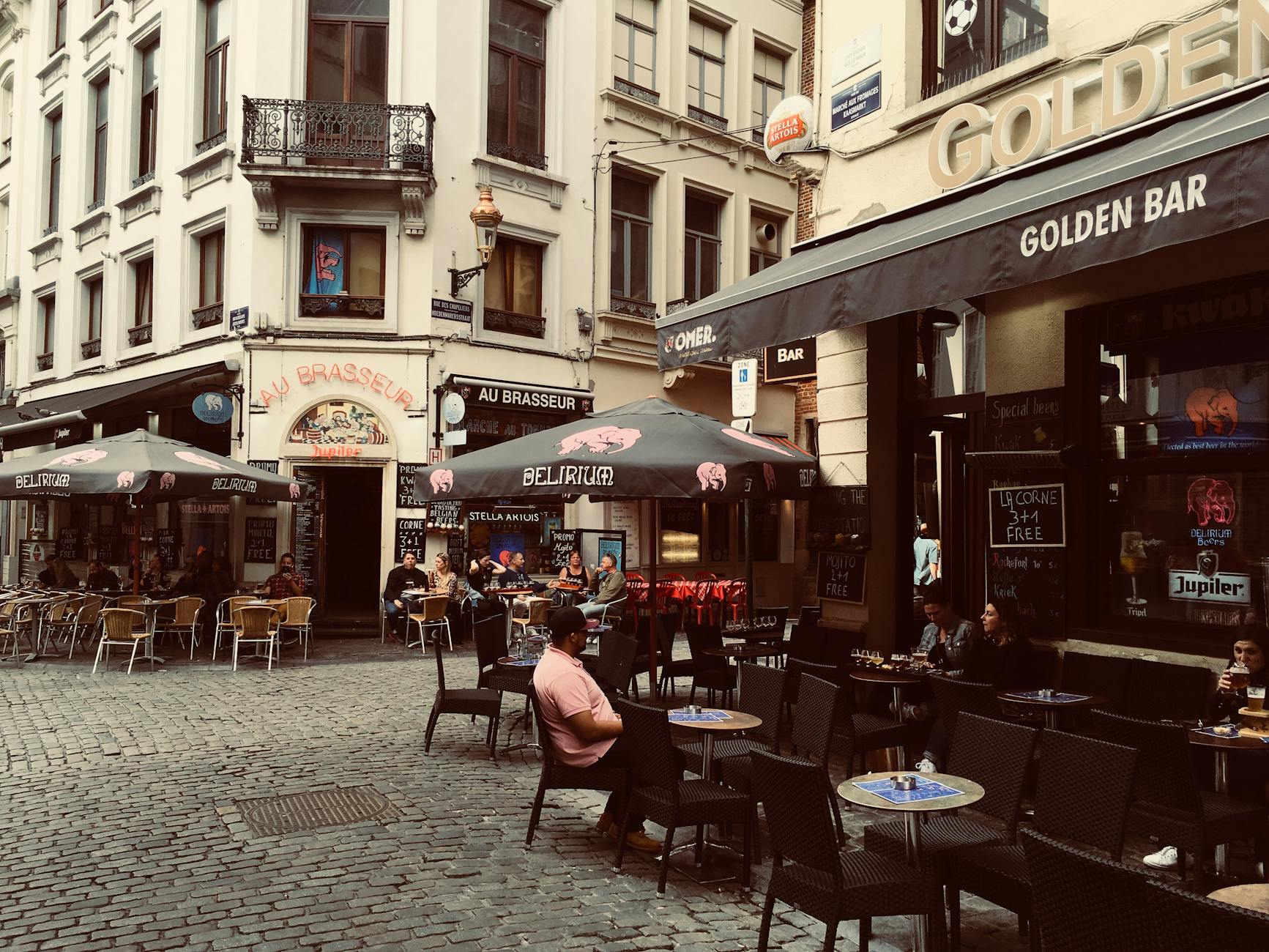 Outdoor cafes in a historic Brussels street, capturing the vibrant city life and European architecture.